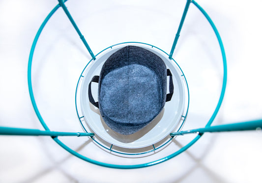 Top-down view of single 5-gallon fabric grow bag placed on the Bloom Carousel’s 22-inch rotating tray, framed by teal steel ring and vertical supports.